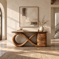 Console table with an infinity loop base and a stacked block at one end in a bright open plan entryway
