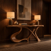 Console table with swooping left leg, crossed branch legs and natural edge top in an evening entryway with walnut wall paneling