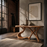 Console table with swooping left leg, crossed branch legs and natural edge top in an industrial loft entryway with exposed brick