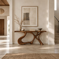 Console table with swooping left leg, crossed branch legs and natural edge top in a bright open plan entryway