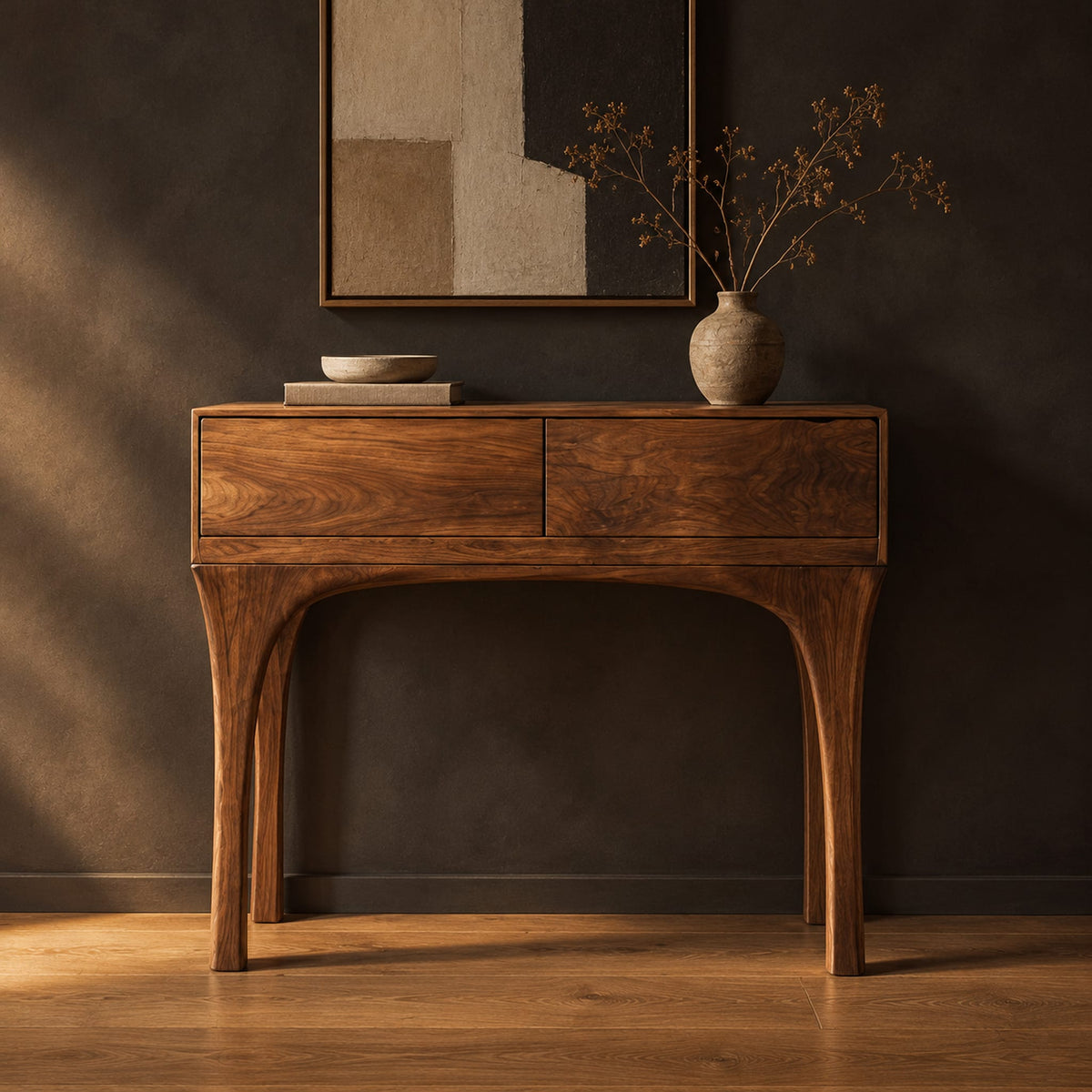 Console table with slim tapered legs and a boxy two panel top in a dark studio against a charcoal plaster wall