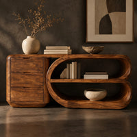 Corner detail of console table with a three drawer block and a looped open shelf unit beside wood, brass and linen samples