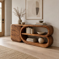 Console table with a three drawer block and a looped open shelf unit in a Scandinavian entryway with white walls