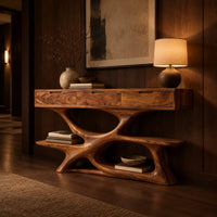 Console table with three drawers over a twisting open loop base and low shelf in an evening entryway with walnut wall paneling