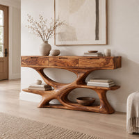Console table with three drawers over a twisting open loop base and low shelf in a Scandinavian entryway with white walls
