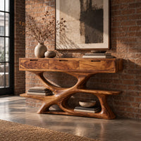Console table with three drawers over a twisting open loop base and low shelf in an industrial loft entryway with exposed brick