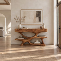 Console table with three drawers over a twisting open loop base and low shelf in a bright open plan entryway