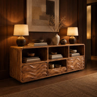Low console cabinet with three open cubbies above two wave carved front panels in an evening entryway with walnut wall paneling