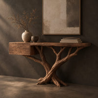 Corner detail of console table with a twisting branch base and a drawer unit at one end beside wood, brass and linen samples