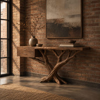 Console table with a twisting branch base and a drawer unit at one end in an industrial loft entryway with exposed brick