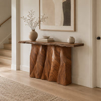 Console table with a wave carved fluted base and a live edge top in a Scandinavian entryway with white walls