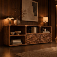 Console table with wave carved front panels and open cubbies in an evening entryway with walnut wall paneling