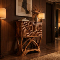 Tall cabinet with carved wavy fronts on a base of branching crossed legs in an evening entryway with walnut wall paneling