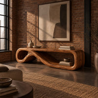 Low tv stand formed from one curling ribbon of wood in an industrial loft living room with exposed brick