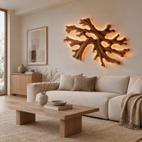 Coral shaped branching wall light with a warm halo of glow behind it in a Scandinavian living room with white walls