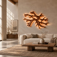 Coral shaped branching wall light with a warm halo of glow behind it in a bright open plan living room