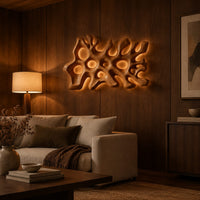 Wide wall sconce shaped like branching coral with pierced openings in an evening living room with walnut wall paneling