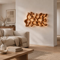 Wide wall sconce shaped like branching coral with pierced openings in a Scandinavian living room with white walls