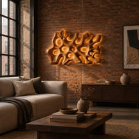 Wide wall sconce shaped like branching coral with pierced openings in an industrial loft living room with exposed brick