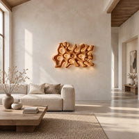 Wide wall sconce shaped like branching coral with pierced openings in a bright open plan living room