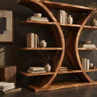 Corner detail of bookshelf with two facing crescent frames and wide open shelves beside wood, brass and linen samples