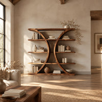 Bookshelf with two facing crescent frames and wide open shelves in a bright open plan living room