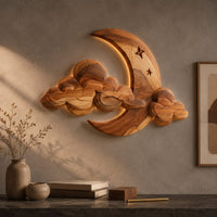 Detail of crescent moon and layered cloud wall art with two small stars beside wood, brass and linen samples