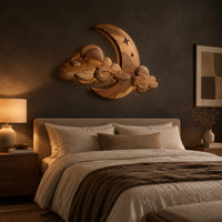 Crescent moon and layered cloud wall art with two small stars above a bed in a dusk lit bedroom