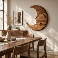 Crescent moon wooden wall art with two carved stars and layered waves beside a dining table in natural light