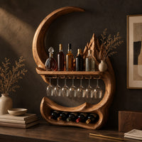 Corner detail of crescent moon wine rack with a carved peak, a shelf and a glass rail beside wood, brass and linen samples