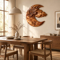 Crescent shaped wooden wall art carved with layered clouds and waves beside a dining table in natural light
