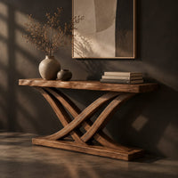 Console table with crossing bowed legs on a thick base and a plank top, three-quarter view showing the grain