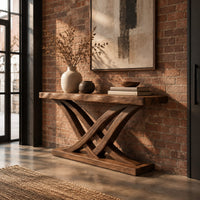 Console table with crossing bowed legs on a thick base and a plank top in an industrial loft entryway with exposed brick