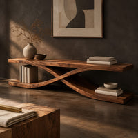 Corner detail of low open tv stand with curved ribbons crossing in an x shape beside wood, brass and linen samples