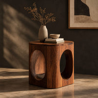 Cube shaped side table with large oval cut outs and softened edges, three-quarter view showing the grain