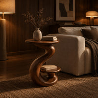Curling swirl side table with a wide top and a small nested disc shelf in an evening living room with walnut wall paneling