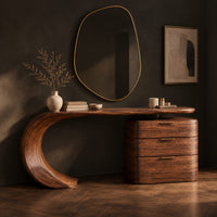 Makeup vanity with a sweeping curved leg and a block of three drawers, three-quarter view showing the grain