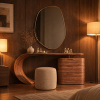 Makeup vanity with a sweeping curved leg and a block of three drawers in an evening bedroom with walnut wall paneling