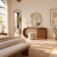 Makeup vanity with a sweeping curved leg and a block of three drawers in a bright open plan bedroom