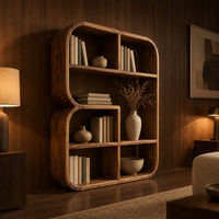 Bookshelf with a thick curved frame and open cubbies of mixed sizes in an evening living room with walnut wall paneling
