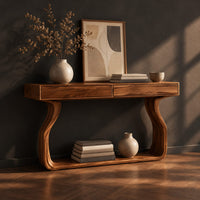 Slim console table on bowed sculpted legs joined by a wide floor rail, three-quarter view showing the grain