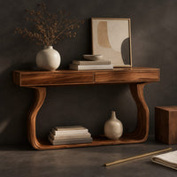 Corner detail of slim console table on bowed sculpted legs joined by a wide floor rail beside wood, brass and linen samples
