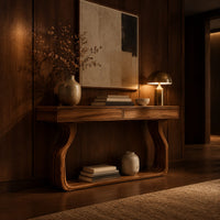 Slim console table on bowed sculpted legs joined by a wide floor rail in an evening entryway with walnut wall paneling