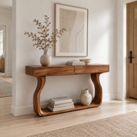 Slim console table on bowed sculpted legs joined by a wide floor rail in a Scandinavian entryway with white walls