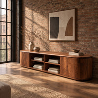 Long tv stand with curved ends, solid end panels and four open center cubbies in an industrial loft living room with exposed brick