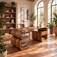 Curved loop desk with a stacked shelf base and an open cubby side in a bright home office with arched windows and plants