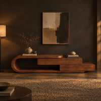 Low tv stand with a looped end and stepped wooden boxes in a dark living room at golden hour