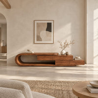 Low tv stand with a looped end and stepped wooden boxes in a bright open plan living room