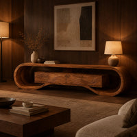 Tv stand with a looping curved frame and a wave carved center box in an evening living room with walnut wall paneling