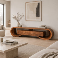 Tv stand with a looping curved frame and a wave carved center box in a Scandinavian living room with white walls